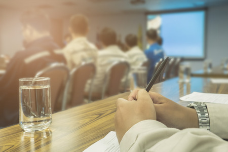 Side view of blurred businessmen talking in conference room. vintage filter effect. selective focus.