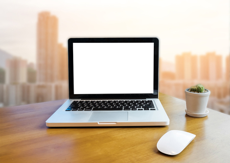 Front view of laptop on table in Office and building blurred background  with morning light.の写真素材
