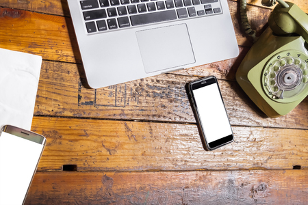 smart phone with blank mobile on wooden desk .Smart phone with blank screen and can be add your texts or others on smart phone.Smart phone and retro concept.の写真素材