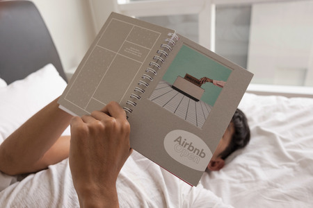 KUALA LUMPUR, MALAYSIA - SEP 04  2016 : Man holding notebook and logo Airbnb. Airbnb is a website for people to list, find, and rent lodging.のeditorial素材