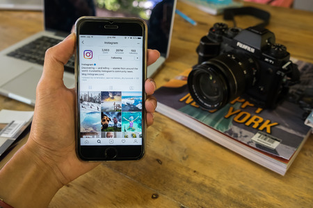 CHIANG MAI, THAILAND - JAN 26, 2017: A man hand holding iphone with new logo of instagram application. Instagram is largest and most popular photograph social networking.のeditorial素材