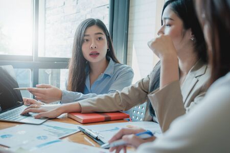 Attractive teamwork discuss and analysis data document in co-working space.