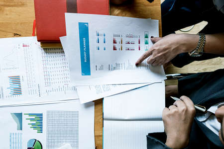 Fund managers team consultation and discuss about analysis Investment stock market by paperwork....