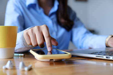 Woman using wireless charging . technology concept.の写真素材