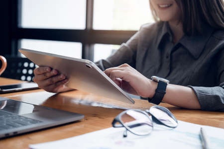 Asian woman Fund managers consultation and discuss about analysis Investment stock market and conference by digital tablet.の写真素材