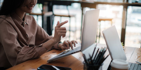 Portrait of businesswoman discussing to her partners about new product while video conference in home office.の写真素材