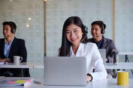 Female operator with her team before communicates with the client.の写真素材