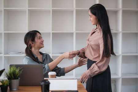 Business partnership meeting concept. Image business womans handshake. Successful business handshaking after good deal. Group support concept.の写真素材