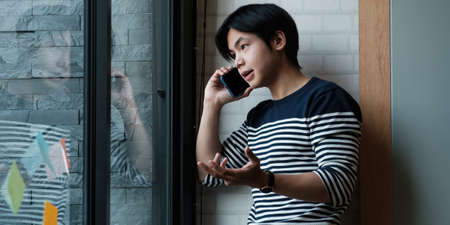 Portrait of businessmen discussing to his partners about new product while talking with mobile phone...