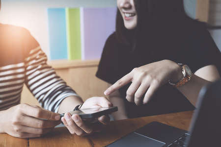 Businesswoman and Businessman using smartphone for compare and share about fund of financial while work from home.の写真素材