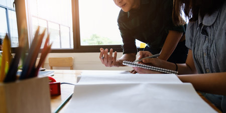 Business engineer and partners hand holding pen with construction drawing. Business engineer and partners discuss with blueprint. consulting planning for engineering concept.の写真素材