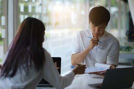 Group of Fund managers researching and analysis Investment stock market by paperwork. Work From Home concept.の写真素材