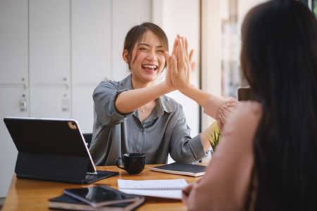 Business start up with team happy with the reward giving for her business success achievement. Achievement and Business Goal Success Concept.の写真素材