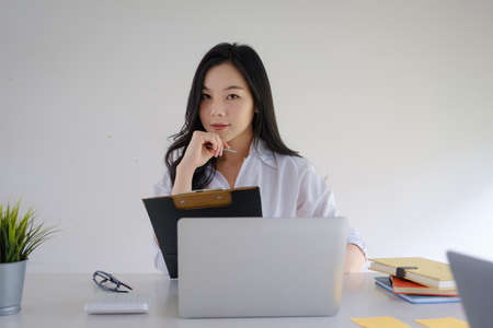 Business woman or accountant making working audit with her team. finance and accounting concept.の写真素材