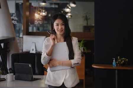 Joyful businesswoman in modern office. Smart, intelligent, friendly, conceptの写真素材
