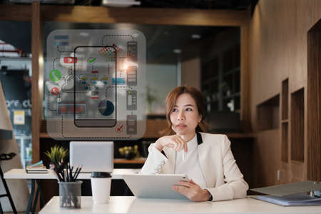 Female ux developer and ui designer sketching interface app in digital tablet in living room at...