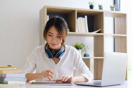 Jouful of creative female designer making a sketch in digital tablet. Creative occupation. Business and career. UX UI design. Web design.の写真素材