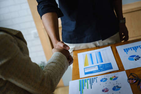 Business people shaking hands after sign in agreement contract