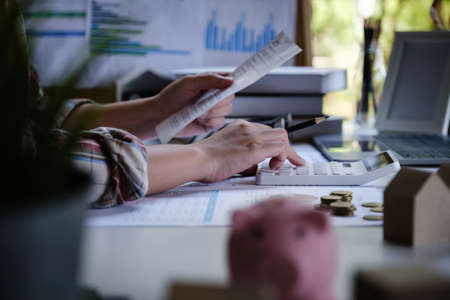 A Men is managing, calculating the debt and holding cost bill.の写真素材