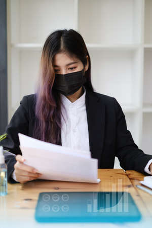 Closeup of Accountant female calculating tax report. Financial, business, analyze concept.の写真素材