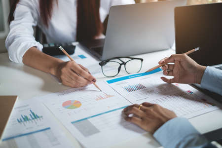 Group of Businesswoman and Accountant checking data document on paperwork for investigation of...
