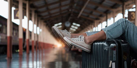 Alone traveler tourist walking with luggage at train station. work and travel lifestyle concept.の写真素材