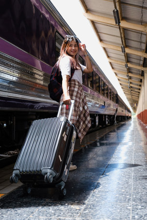 Alone traveler tourist walking with backpack and luggage at train station. work and travel lifestyle concept.の写真素材