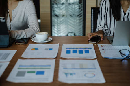 Marketing plan researching. Paperwork on the paperwork on wooden desk in office. Brainstorming Group of people Working Conceptの写真素材