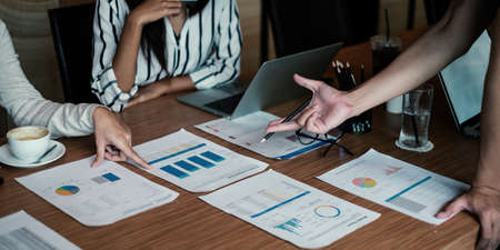 Group of business people discuss current financial and economic paperwork for investment at the...