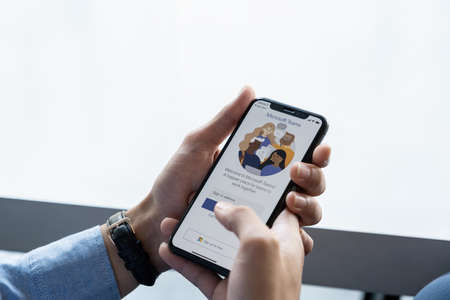 CHIANG MAI, THAILAND - JULY 14, 2021 : A Businessman working from home employee. Microsoft Team is platform that combines persistent chat in the workplace.のeditorial素材