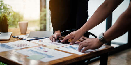 Analytics intelligence concept. Group of business people discuss current financial and economic on...