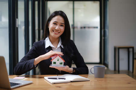A real estate agent demonstrates the House model to clients interested in purchasing house...
