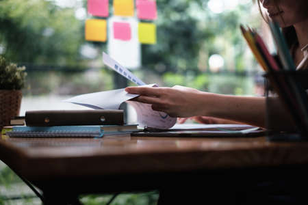 A businesswoman examines a financial chart in order to make arrangements. Investment concept for a...
