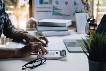 Accounting man estimate and handling finances. The concept of a budget, tax, and loan paperの写真素材