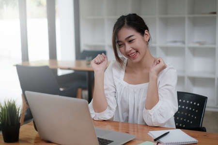 Online class. Young student. young beautiful student success when pass exam.の写真素材