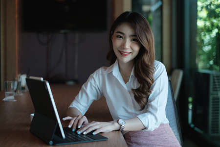 Business woman speaking on video call on online briefing with laptop computer at her officeの写真素材