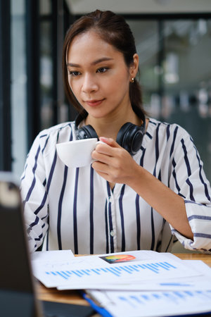 Business woman speaking on video call on online briefing with laptop computer at her officeの写真素材