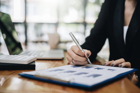 Young undergraduate student studying financial online class by laptop computer.の写真素材