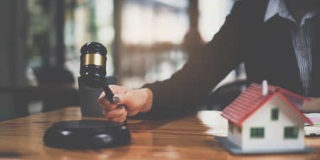 Business woman or legal advisor sitting wooden desk in office. Law, legal services, advice,Judge auction and real estate conceptの写真素材