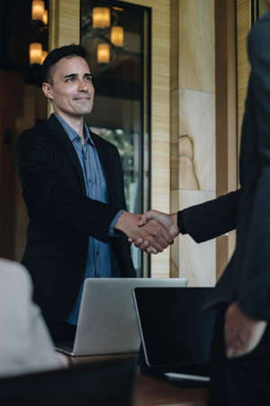Businessman and partner handshake for the new agreement after sign in agreement contract with work together.の写真素材