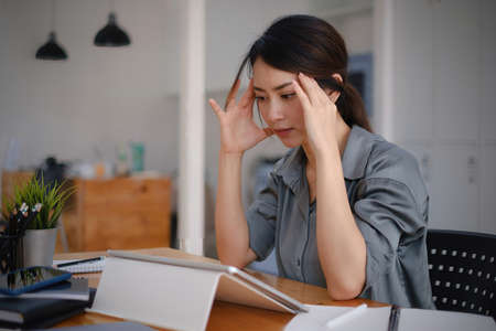 Frustrated stressed business owner or accountant sitting in an office because covid-19 has disappoint. Close business cafe shop concept.の写真素材