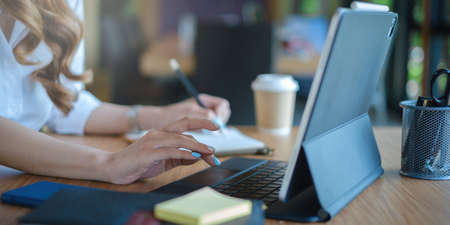 Business team working together and training to analyze technical price graph and indicator. Chart and stock trading tablet screen.の写真素材