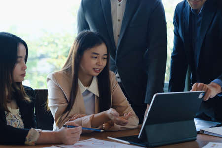 Team leaders of business meeting and discuss marketing and investment plan for next years on digital tablet with business teamの写真素材