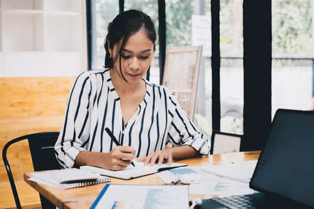 Business people gather in a corporate location to discuss research using paperwork. Concept of a...