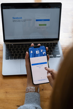 CHIANG MAI, THAILAND - OCT 18, 2021: A woman holds Apple iPhone 6S with facebook application on the screen.facebook is a photo-sharing app for smartphones. facebook is a social network.のeditorial素材