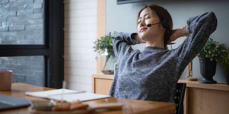 Businesswoman relaxing after in having a video call on laptop while discussion with business partner...
