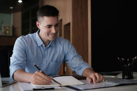 American employee working with stock trading document in home office. Business financial concept.の写真素材