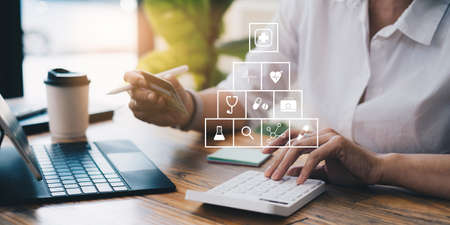 Healthcare Insurance Medical concept. Adult woman calculate cost for payment online pharmacy or healthcare Insurance.の写真素材