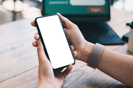 A woman hand holding smartphone device with blank screen. Blank screen for your advertising.の写真素材