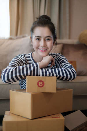 Asian small business owner at home office. Business retail market and online sell marketing delivery, SME e-commerce concept.の写真素材